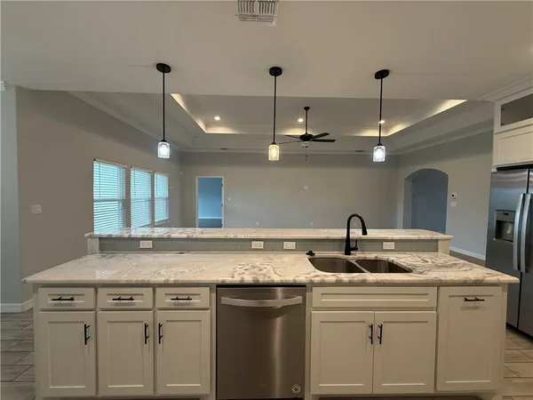 a kitchen with a sink and a refrigerator
