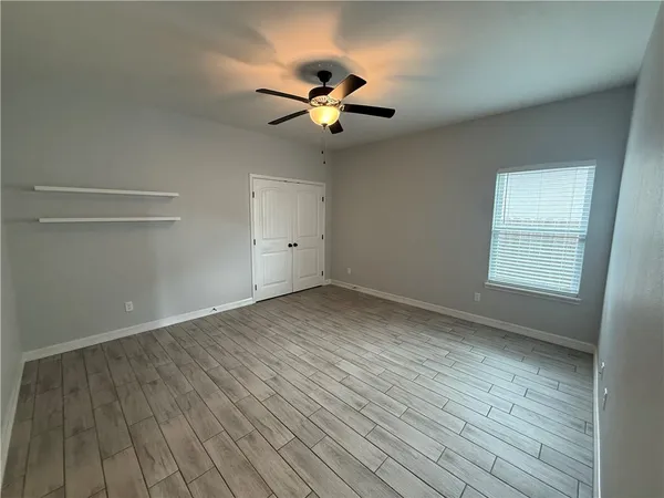 wooden floor in an empty room with a window