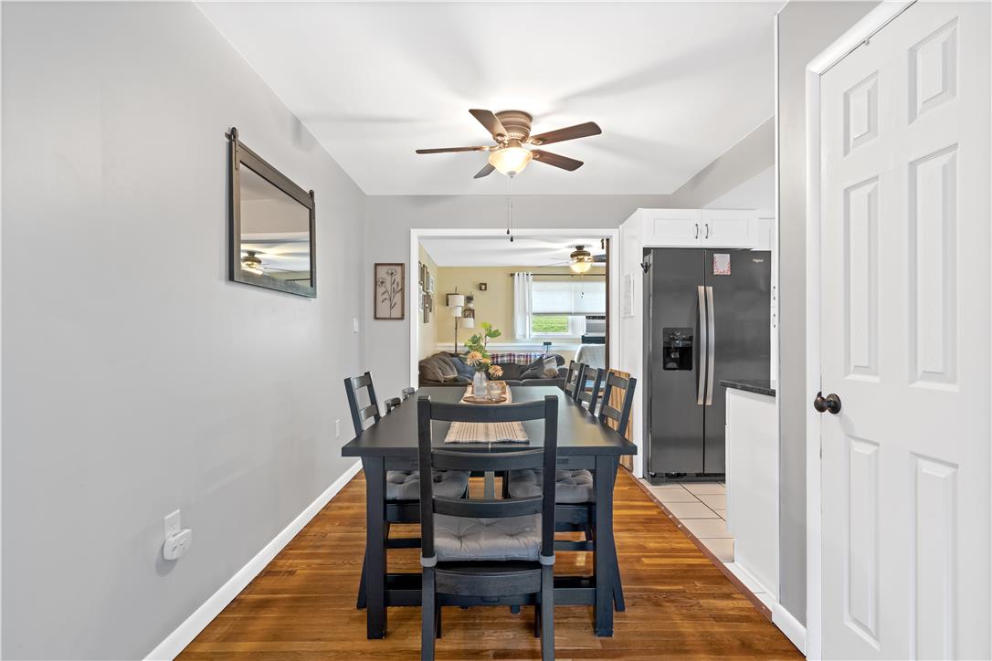 50 Kohls Road Northampton, PA 18067 - Photo 14 of 54 Hardwood floors stretch across the open-concept dining area, seamlessly connecting to the kitchen and living spaces.