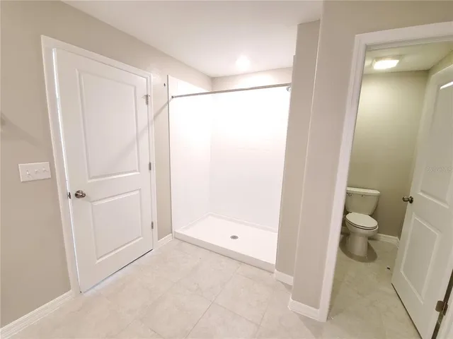 a bathroom that has a glass shower door