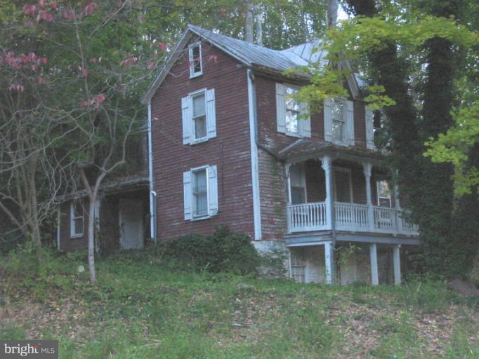 19234 Falls Road Hampstead, MD 21074 - Photo 2 of 11 a front view of a house with a yard