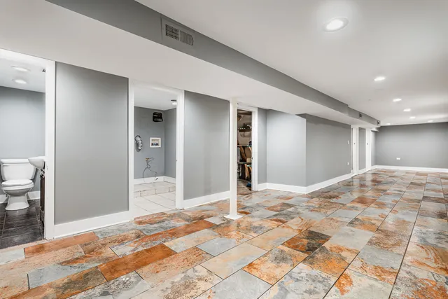 a view of a bedroom with wooden floor and bathroom space
