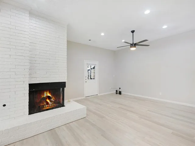 a view of an empty room with fire place and fire place