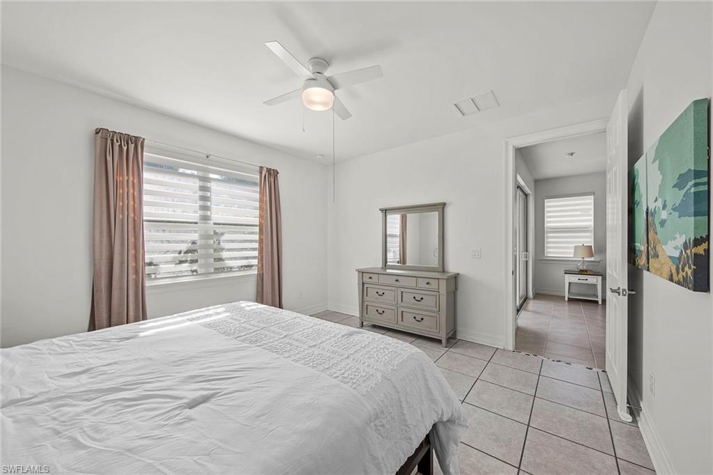 28419 Captiva Shell Loop Bonita Springs, FL 34135 - Photo 18 of 41 a bedroom with a large bed and a chandelier