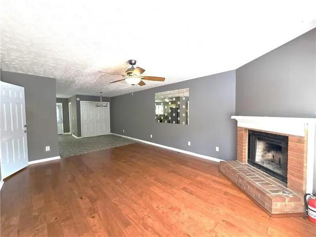 a view of an empty room with a fireplace