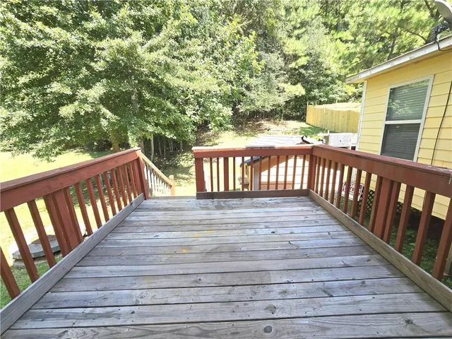 a view of deck with wooden floor and fence