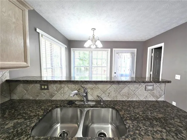 a kitchen with a sink and a window