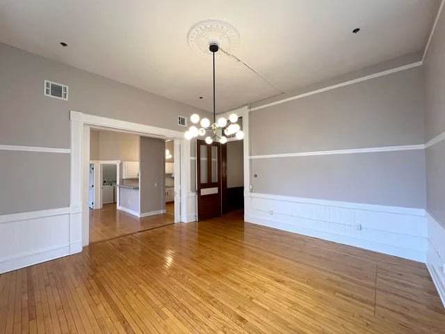 a view of a livingroom with a chandelier fan