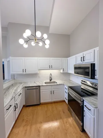 a kitchen with a sink stove and microwave
