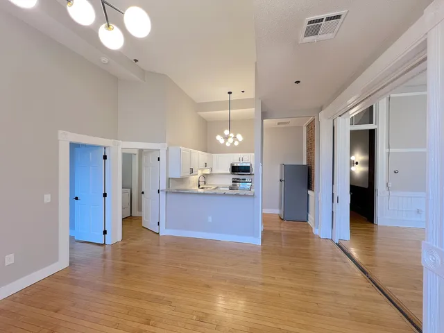 a large kitchen with a refrigerator and a sink