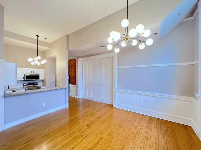 a view of a kitchen with a sink and wooden floor