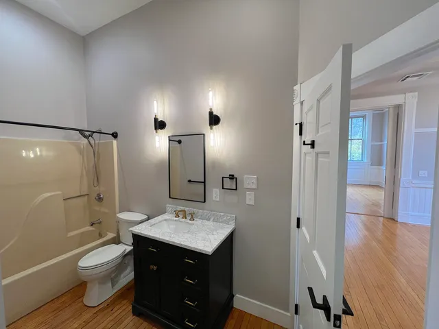 a bathroom with a sink toilet and shower