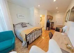 302 Newbury Street, Unit 7 Boston, MA 02115 - Photo 3 of 6 a bedroom with furniture and a wooden floor