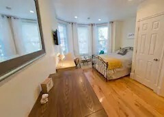 302 Newbury Street, Unit 7 Boston, MA 02115 - Photo 4 of 6 a spacious bedroom with a bed and a window