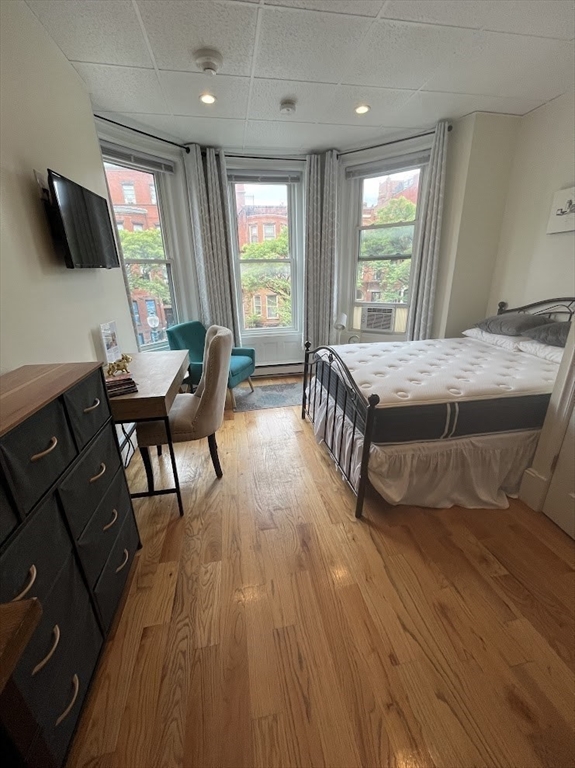 302 Newbury Street, Unit 7 Boston, MA 02115 - Photo 6 of 6 a room with furniture pool table flat screen tv and windows