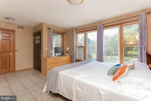 a bedroom with a large bed and a large window