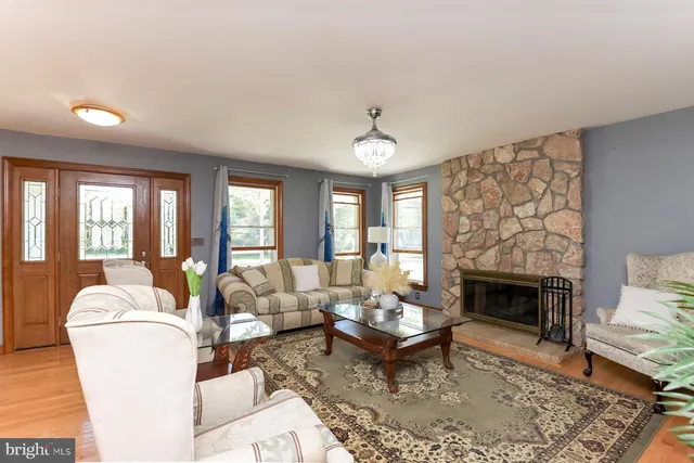 a living room with furniture fireplace and window