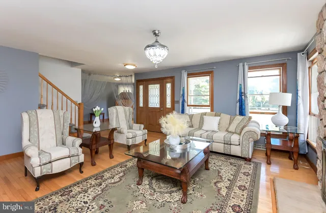 a living room with furniture a table and a large window