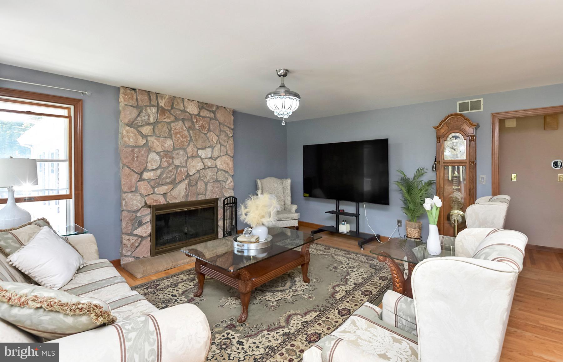 467 Gordon Road Robbinsville, NJ 08691 - Photo 6 of 41 a living room with furniture a flat screen tv and a fireplace