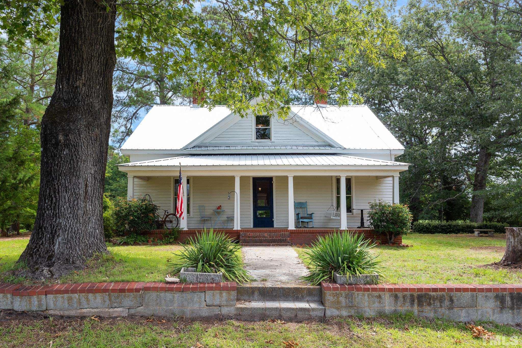 599 Federal Road Benson, NC 27504 - Photo 1 of 30 a front view of a house with garden