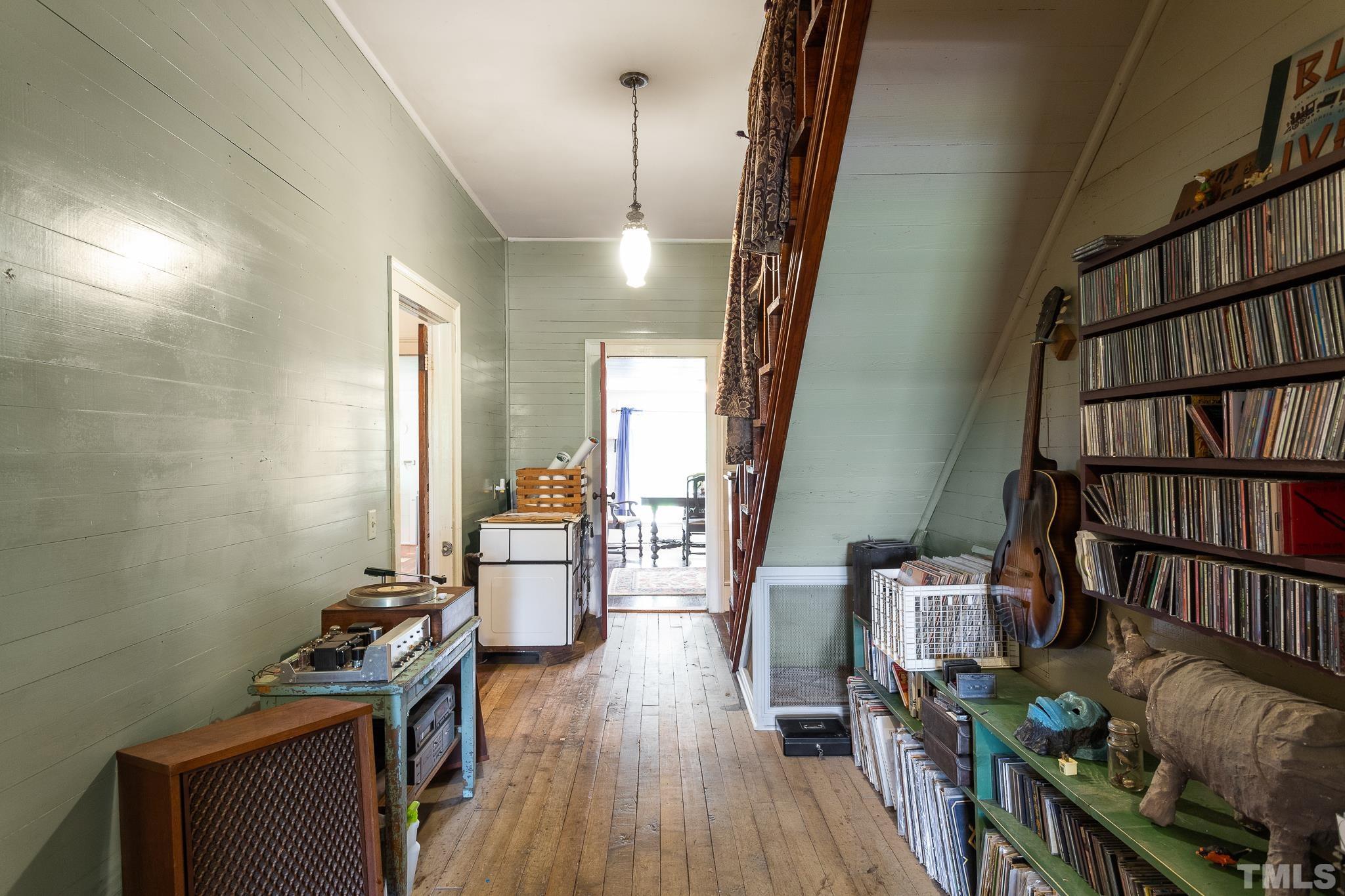599 Federal Road Benson, NC 27504 - Photo 14 of 30 a view of empty room with wooden floor and book shelf