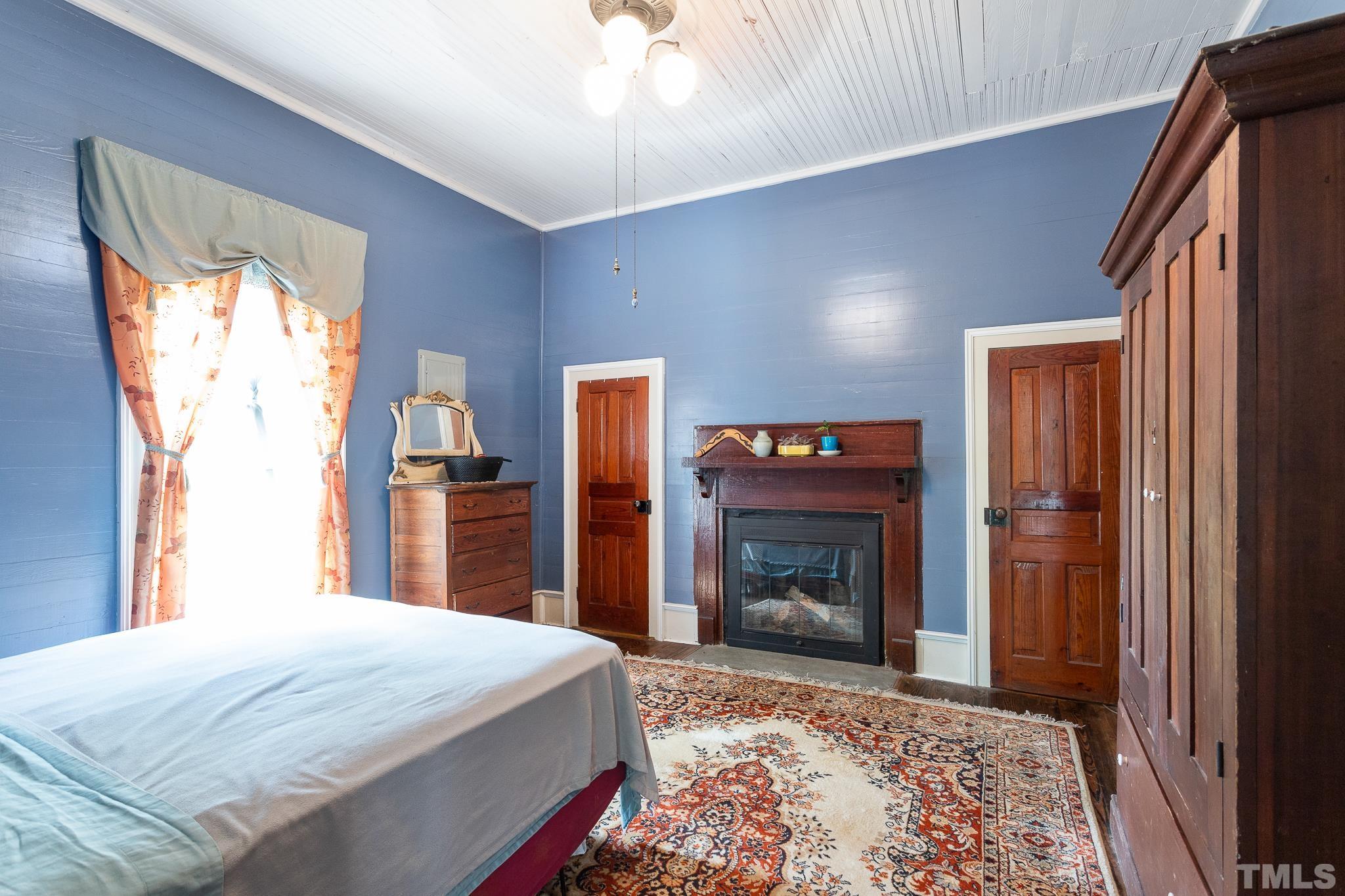 599 Federal Road Benson, NC 27504 - Photo 25 of 30 a bedroom with a bed and a fireplace
