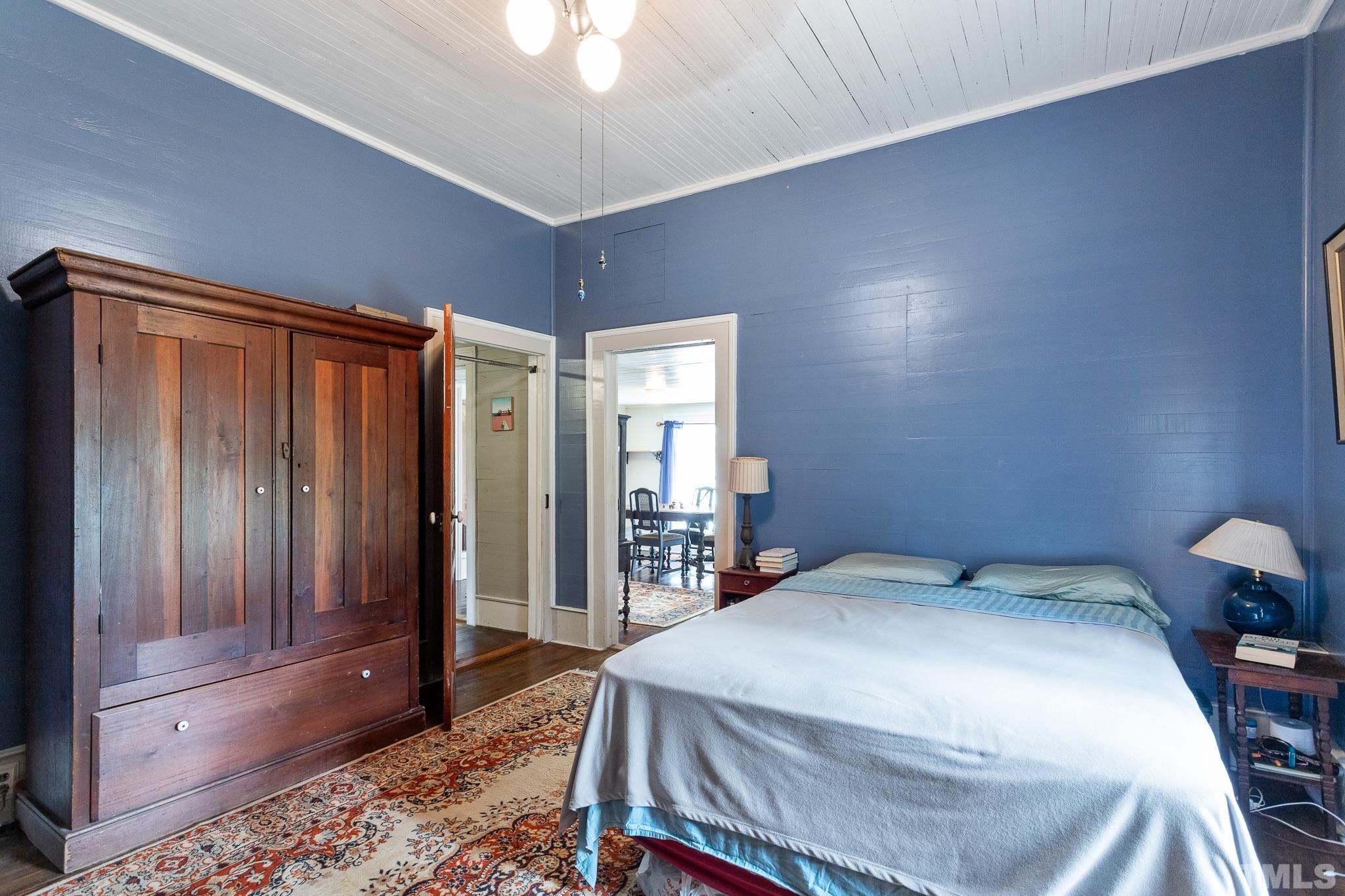 599 Federal Road Benson, NC 27504 - Photo 26 of 30 a bedroom with a bed and a chandelier