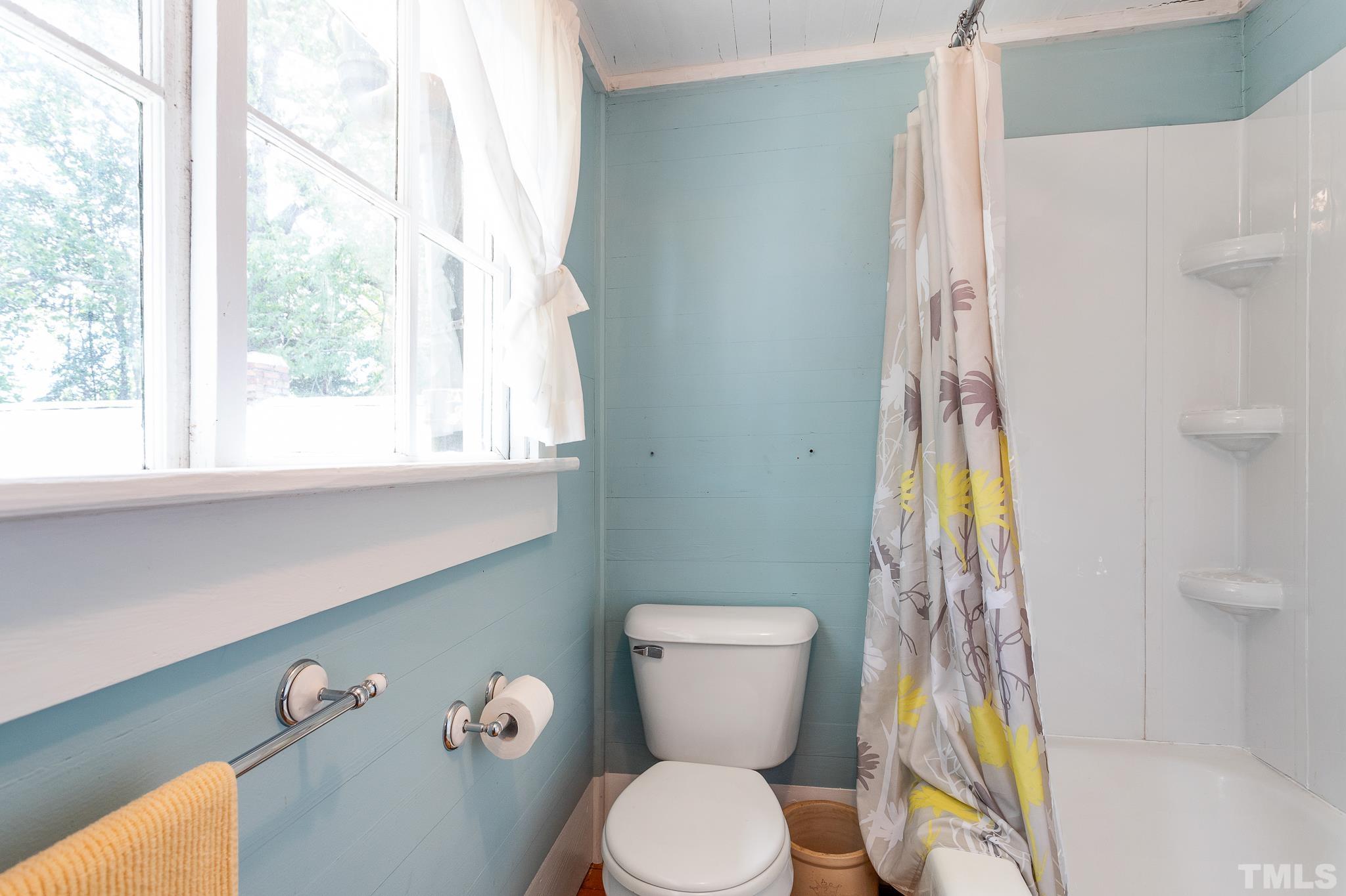 599 Federal Road Benson, NC 27504 - Photo 28 of 30 a white toilet sitting next to a bathroom sink and a window