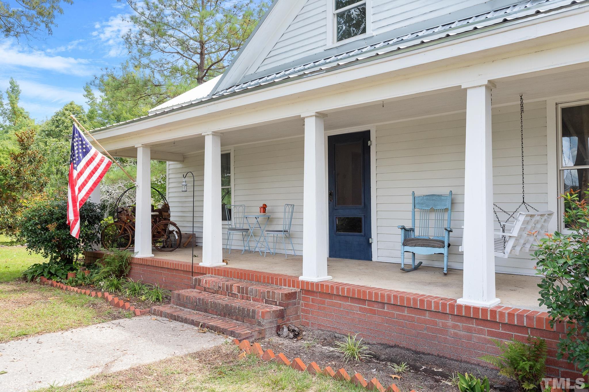 599 Federal Road Benson, NC 27504 - Photo 3 of 30 a view of a house with backyard sitting area and porch