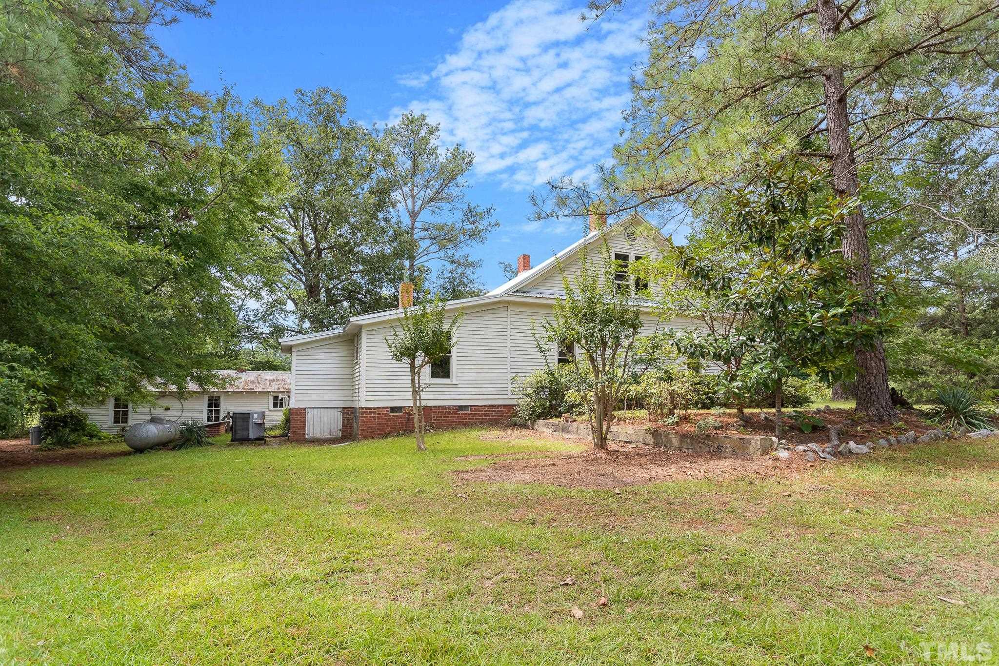 599 Federal Road Benson, NC 27504 - Photo 5 of 30 a view of a house with a yard and tree s