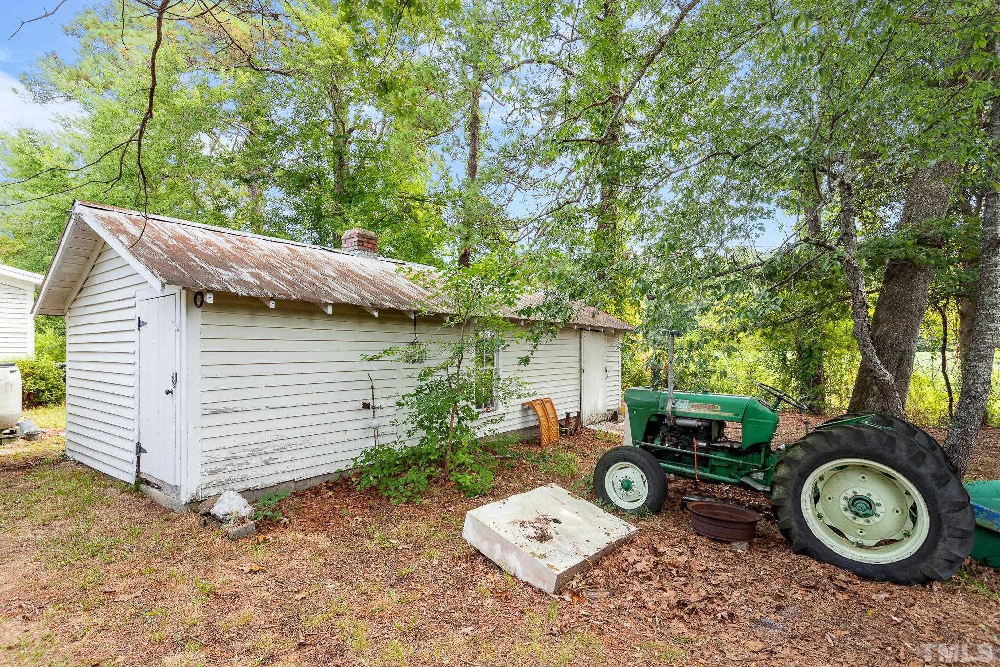 599 Federal Road Benson, NC 27504 - Photo 7 of 30 a view of a house with backyard space and a car parked