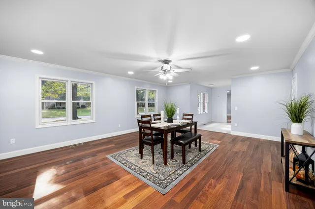 a bathroom with a sink a mirror and a vase of flowers