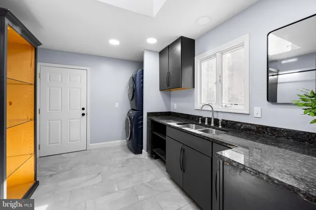 a view of an empty room with chandelier fan
