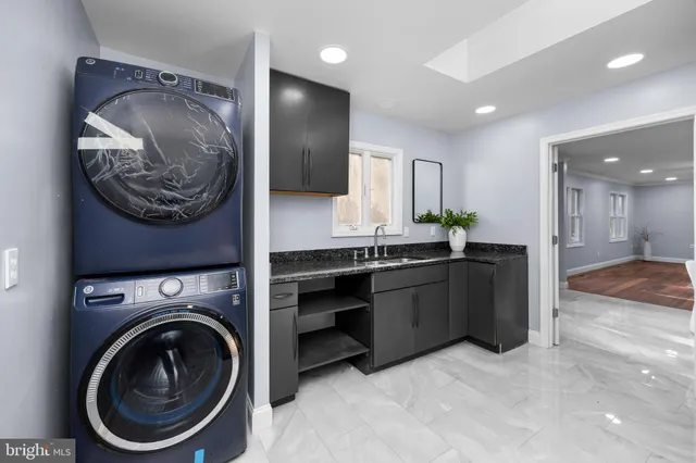 a view of an empty room and chandelier fan