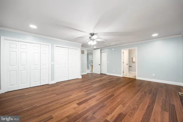 a view of a room with wooden floor and windows