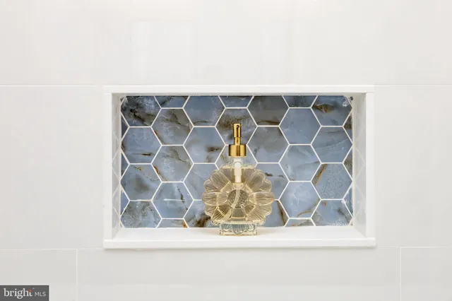 an empty room with wooden floor ceiling fan and windows