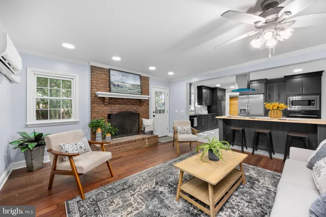 a kitchen with stainless steel appliances kitchen island granite countertop a table chairs and a refrigerator