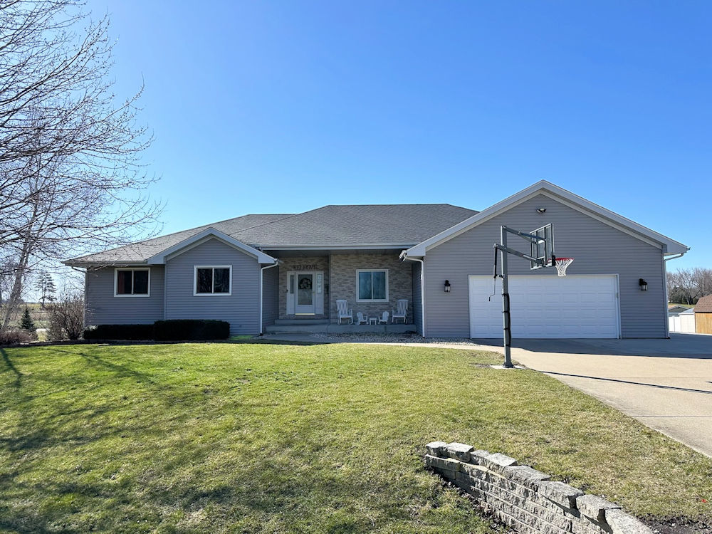 10965 Barron Road Chana, IL 61015 - Photo 1 of 27 a house that is sitting in the grass with large trees