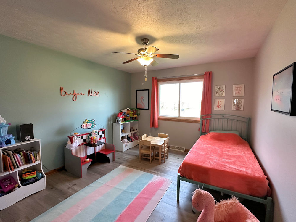 10965 Barron Road Chana, IL 61015 - Photo 13 of 27 a bedroom with bed and a workspace