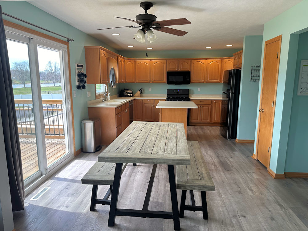 10965 Barron Road Chana, IL 61015 - Photo 3 of 27 a kitchen with a table chairs refrigerator and microwave