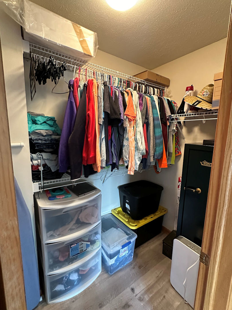 10965 Barron Road Chana, IL 61015 - Photo 8 of 27 a view of walk in closet with clothes and shoes