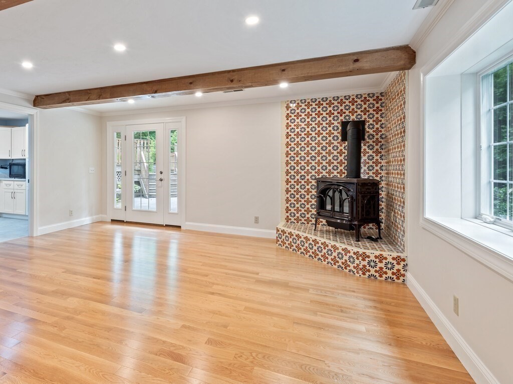 1 Corbin Road Dudley, MA 01571 - Photo 20 of 42 a view of empty room with wooden floor and fireplace