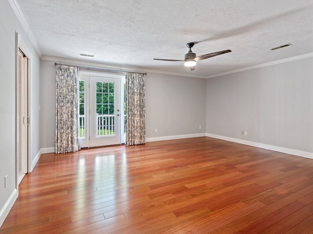 1 Corbin Road Dudley, MA 01571 - Photo 26 of 42 an empty room with wooden floor fan and windows