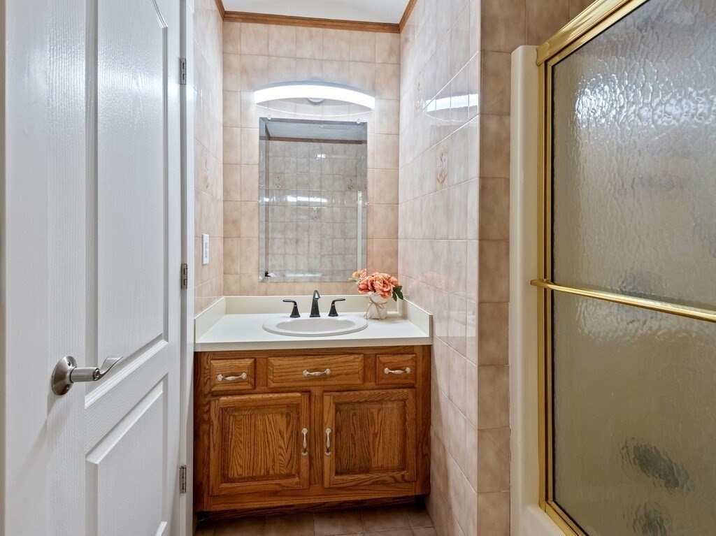 1 Corbin Road Dudley, MA 01571 - Photo 36 of 42 a bathroom with a granite countertop sink a mirror and a shower