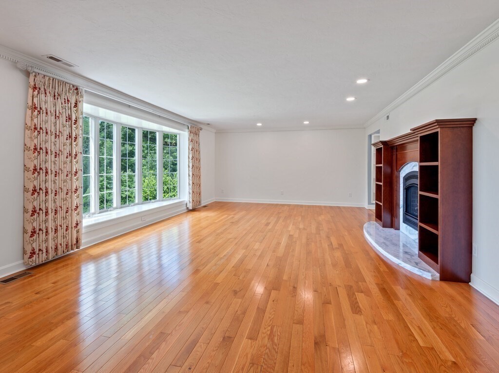1 Corbin Road Dudley, MA 01571 - Photo 7 of 42 a view of empty room with wooden floor and fireplace