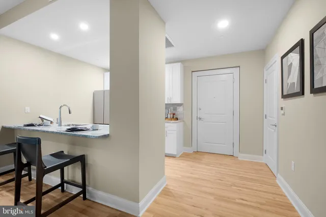 a bedroom with a large bed and a flat tv screen on dresser