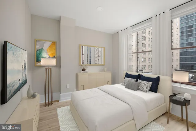 a bedroom with bed and a flat screen tv