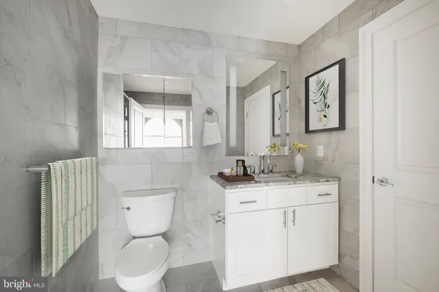 a room with lots of furniture and painting on the wall