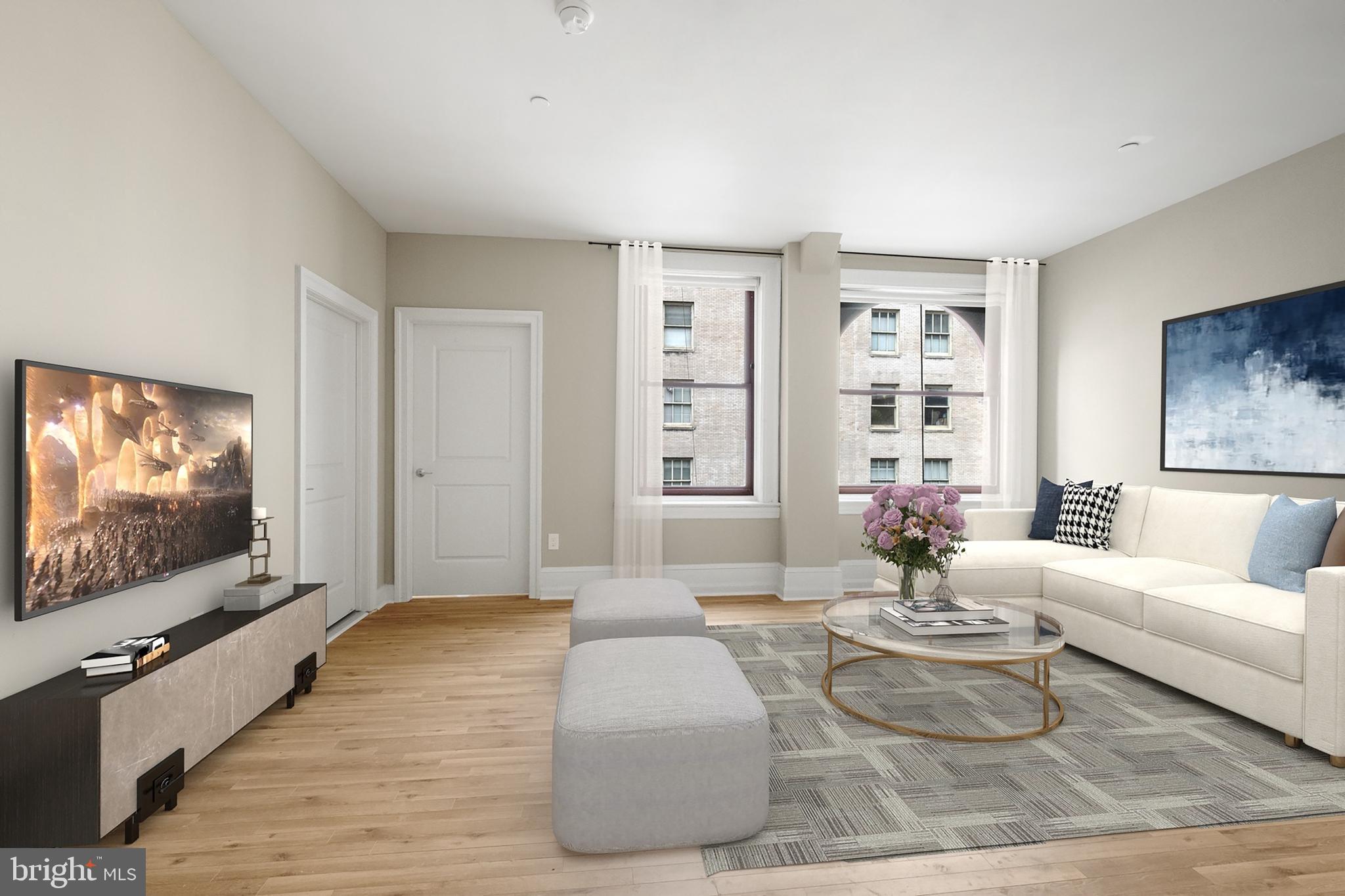 1420-22 Chestnut Street, Unit 407 Philadelphia, PA 19102 - Photo 7 of 35 a living room with furniture and a flat screen tv