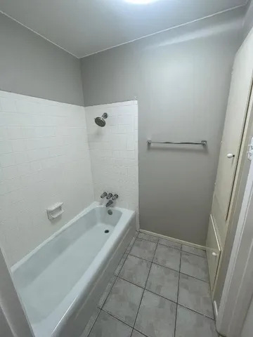 a bathroom with a bathtub and shower